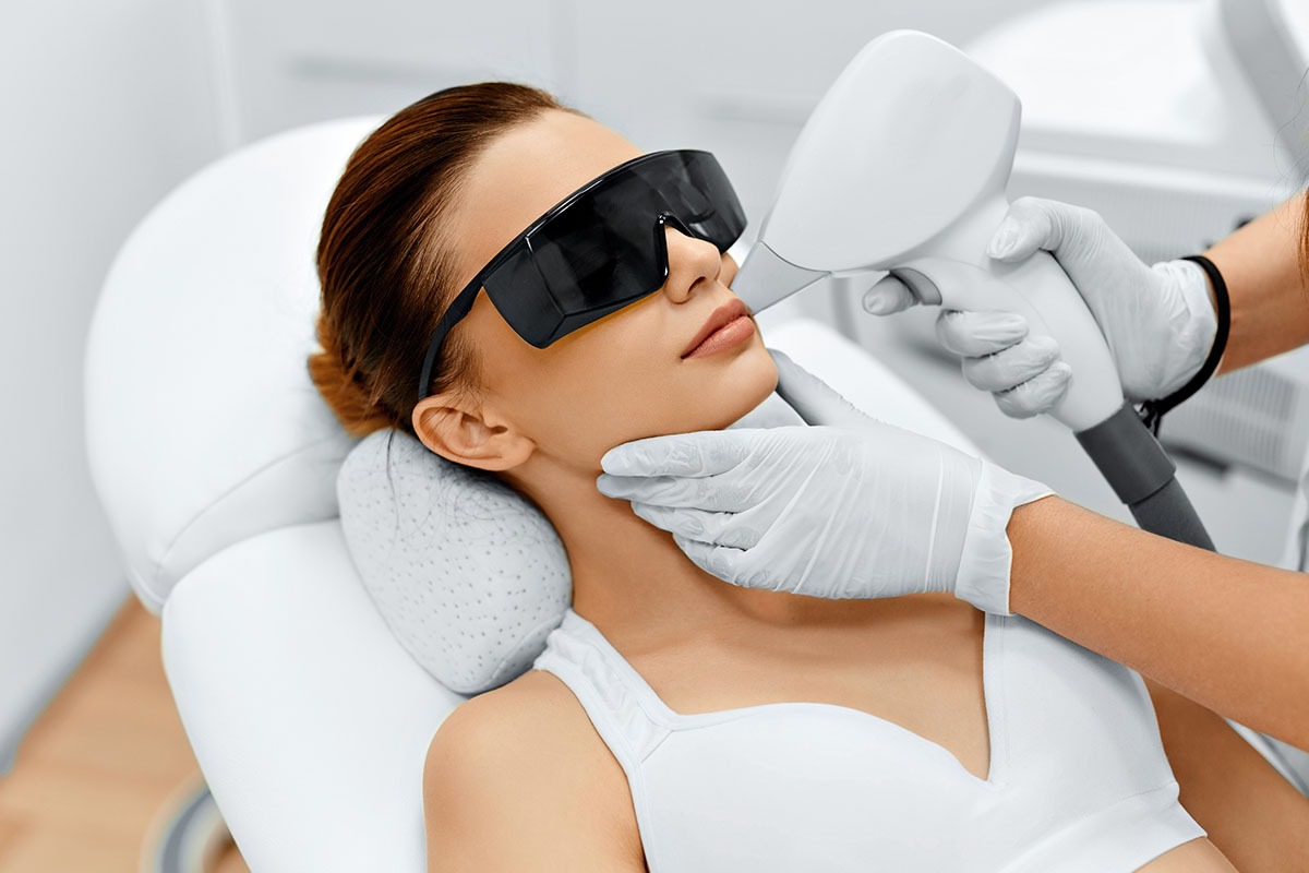 Female patient receiving facial laser hair removal